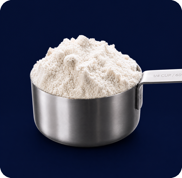 Measuring spoon with powder on a navy background
